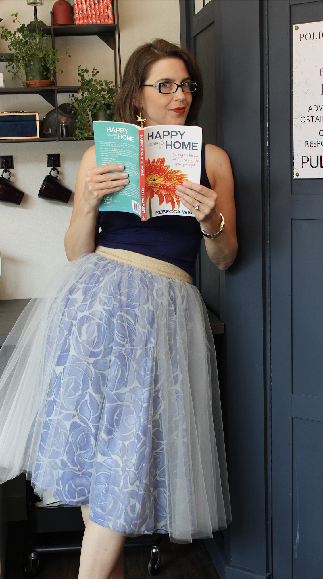 Rebecca West author of design psychology book Happy Starts at Home, holding first edition circa 2016