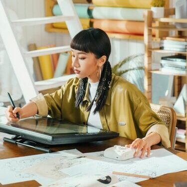 Photo by TourBox Artist works on a digital tablet in her studio.